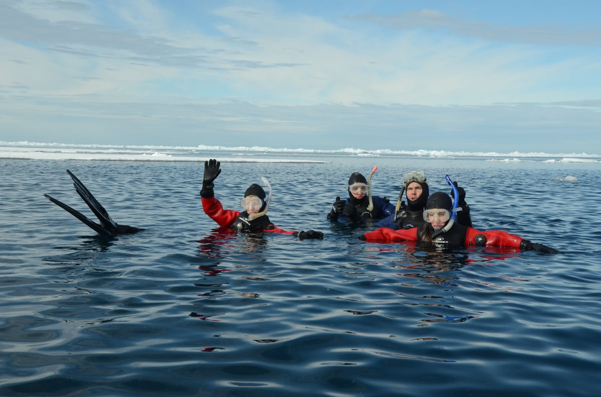 ARCTIC_KINGDOM_snorkelers in water_MIKE Beedell DSC_8853